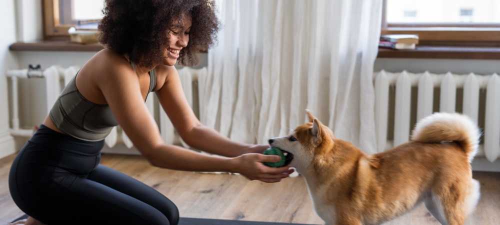 woman playing with dog